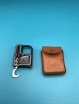 Vintage Fishing Langley Fisherman's De-liar, Tape Measure/weight Scale Case. Fixed Price $22.00.