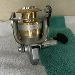 Daiwa Sweepfire 3000-2B Spinning Reel Gold/silver/black Right Front Drag. Fixed Price $75.00.